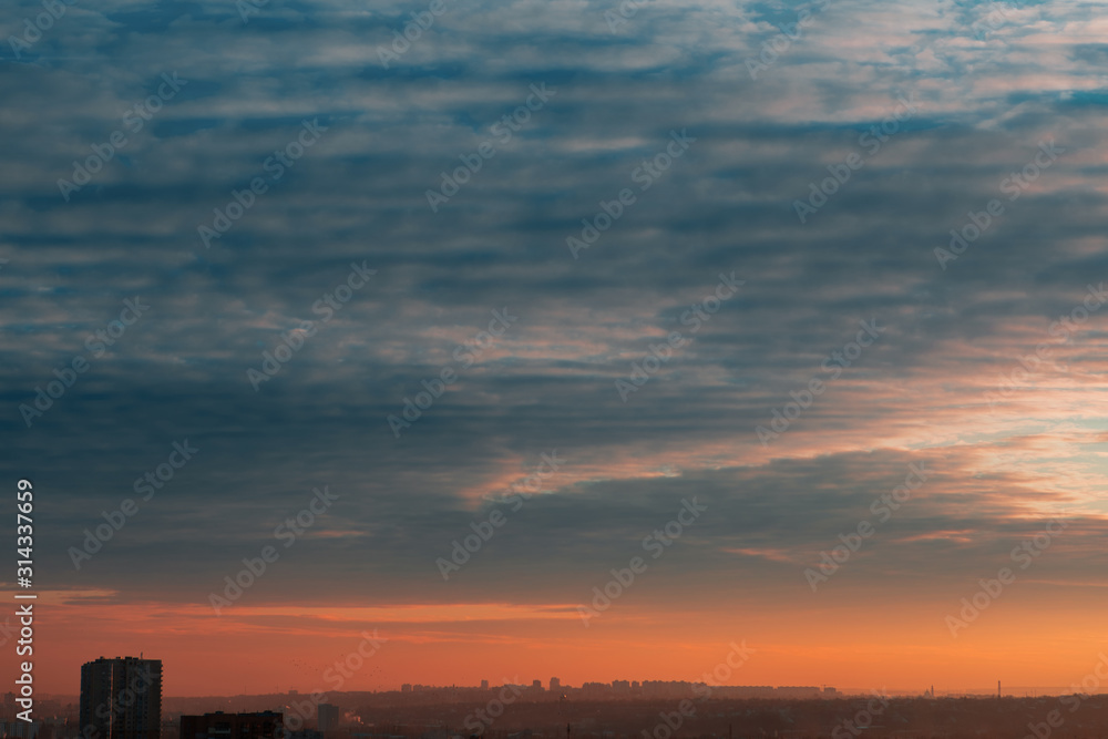 Beautiful sky with clouds over the city at sunset Beautiful sky with clouds over the city at sunset