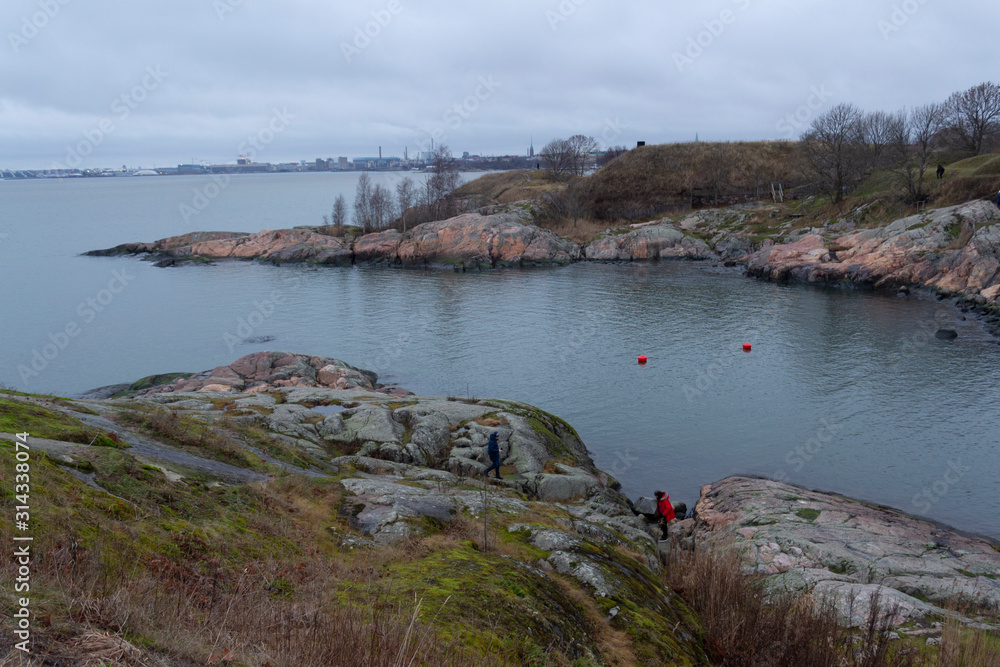 A bay on the island of Suomenlinna surrounded by granite shores on an autumn day near the city of Helsinki in Finland.