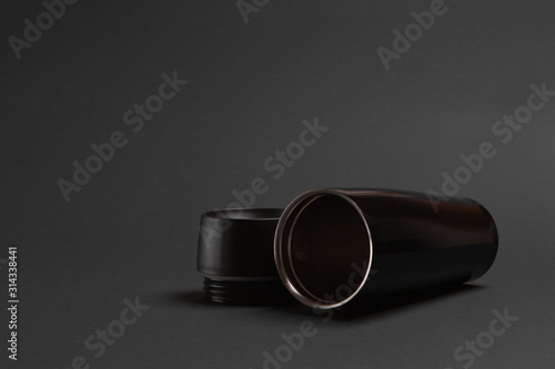 one black thermal bottle shaker for sports nutrition on a gray background.