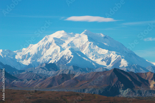 Denali Mountain in Alaska With Blue Sky and Cloud Floating Above the Mountain.