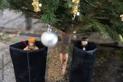 Christmas tree with a bottle of whisky in a shoe photo