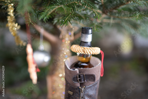 Christmas tree with a bottle of whisky in a shoe photo