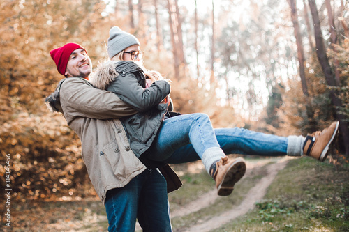 Traveler couple in love so fun in the forest. Concept of trekking, adventure and seasonal vacation.