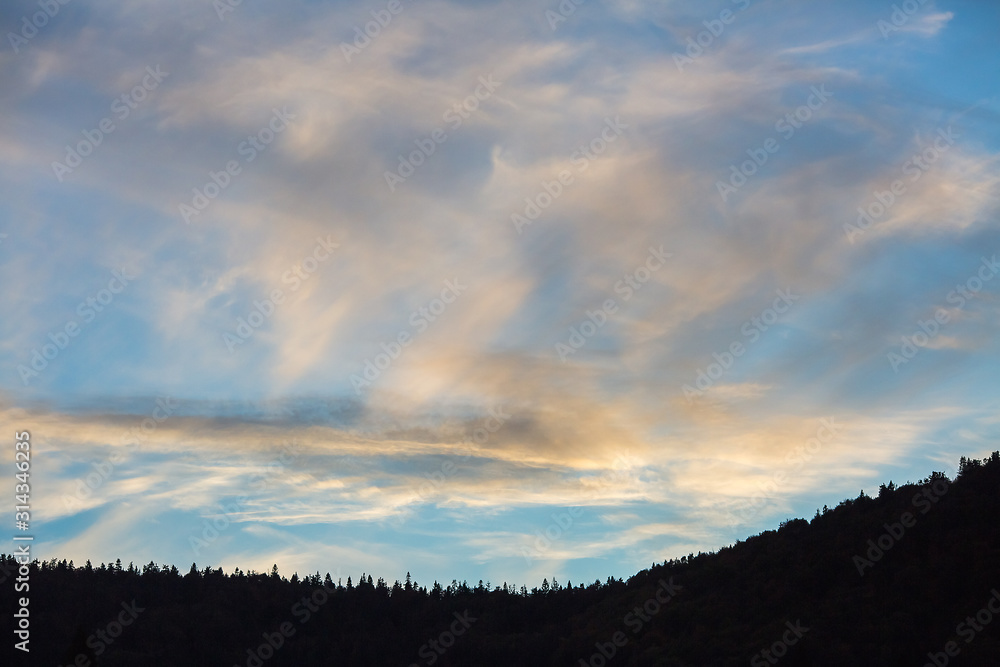 beautiful sunset sky over forest and mountains. beautiful sunset sky over forest and mountains.