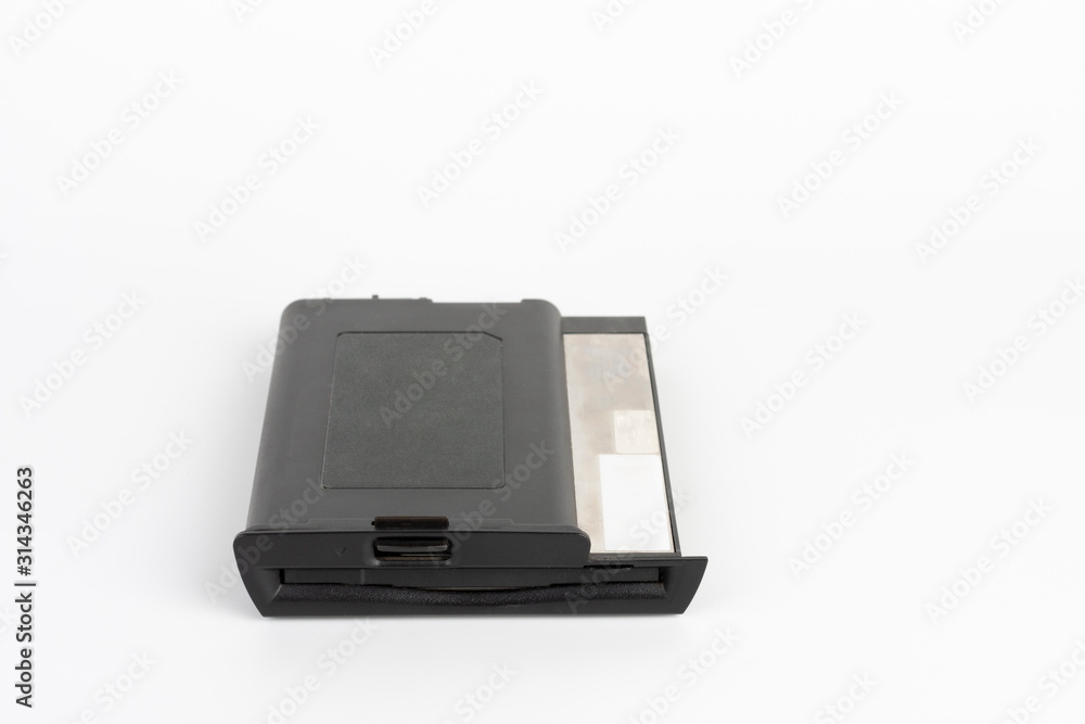Floppy disk drive from 16 year old laptop on white background Floppy disk drive from 16 year old laptop on white background