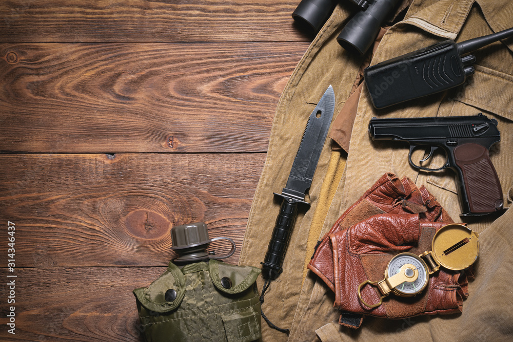 Post apocalypse soldier equipment on the wooden table background