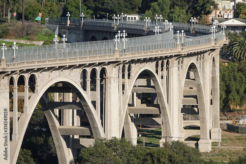 The Colorado Street Bridge is shown spanning the Arroyo Seco (dry stream) in Pasadena, California, USA during the day. The concrete arch bridge was completed in 1913. photo