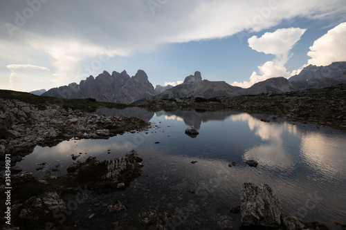 Dolomites mountains in Italy reflection in lake clouds