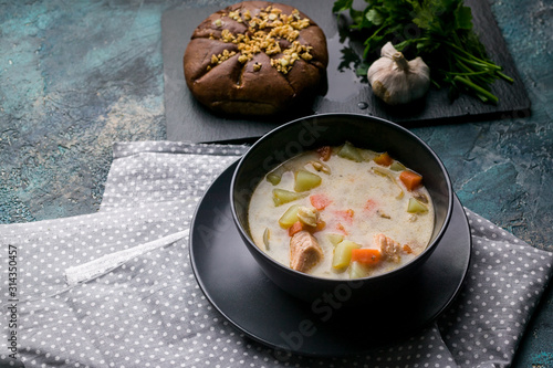 Close up Finnish traditional salmon soup with cream. Kalakeitto. Fish soup with potatoes and carrots.