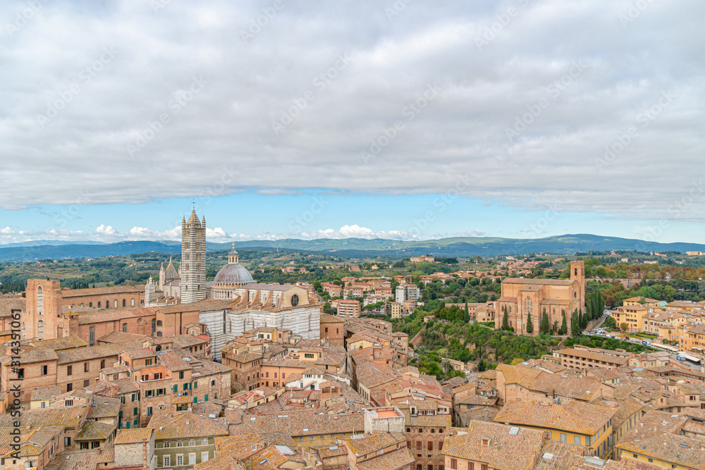 Beautiful aerial panoramic view of Old Town of medieval city of Siena in the cloudy autumn day, Tuscany, Italy