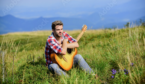Wanderlust concept. Inspiring nature. Summer vacation highlands nature. Musician looking for inspiration. Dreamy wanderer. Pleasant time alone. Peaceful mood. Guy with guitar contemplate nature
