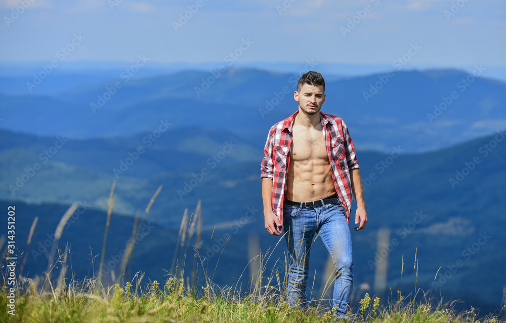 Hiker muscular torso reach mountain peak. Hiking concept. Man stand top mountain landscape background. Athlete guy relax mountains. Beautiful environment. Muscular tourist walk mountain hill Hiker muscular torso reach mountain peak. Hiking concept. Man stand top mountain landscape background. Athlete guy relax mountains. Beautiful environment. Muscular tourist walk mountain hill