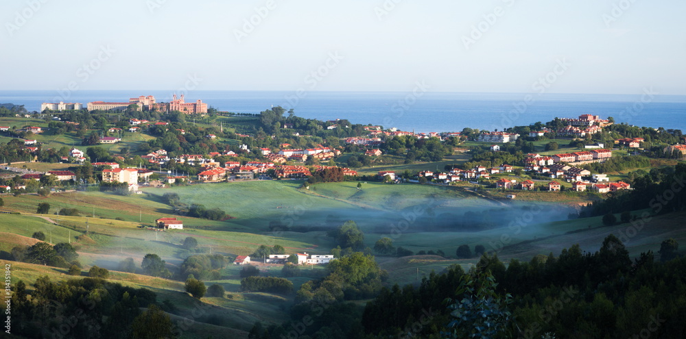 Panorama of Comillas behind the fog of the morning. Cantabria, Spain