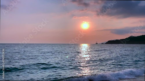 Beautiful red sea sunset footage with old ship. Mountains near ocean. Summer vacation concept