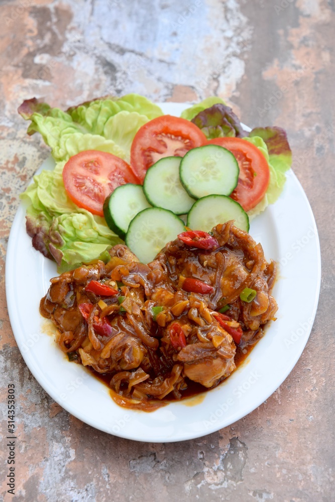 Ayam Kecap. Chicken cooked or stew in thick sweet soy sauce and spices. Served with rice, lettuce, sliced cucumber and tomato Ayam Kecap. Chicken cooked or stew in thick sweet soy sauce and spices. Served with rice, lettuce, sliced cucumber and tomato