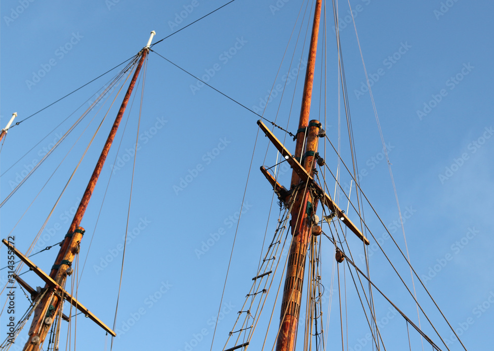 The mast of the yard of a sea Sailer in the Harbor The mast of the yard of a sea Sailer in the Harbor