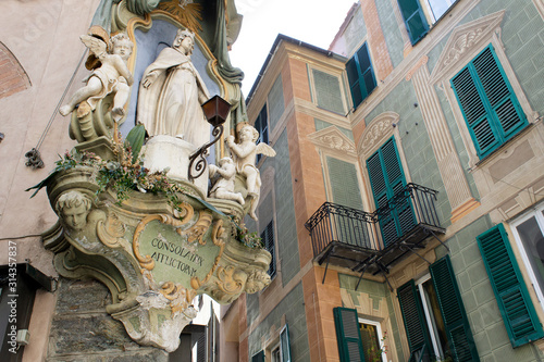 detail of facade Madonna staue old town street facade savona italy