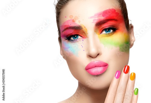 Fashion model girl with rainbow colored abstract makeup. Make-up and nail art concept. Fine art beauty portrait