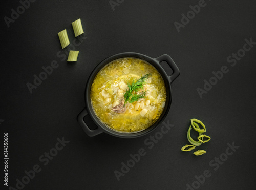 Avgolemono, traditional greek chicken soup with egg lemon sauce photo