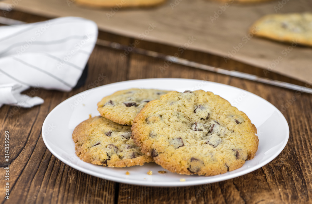 Portion of fresh Chocolate Chip Cookies (selective focus; close-up shot) Portion of fresh Chocolate Chip Cookies (selective focus; close-up shot)