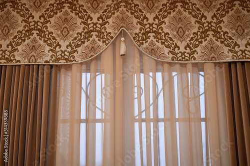 Classic curtains with tapestry insert and brush. A classic window with heavy curtains.