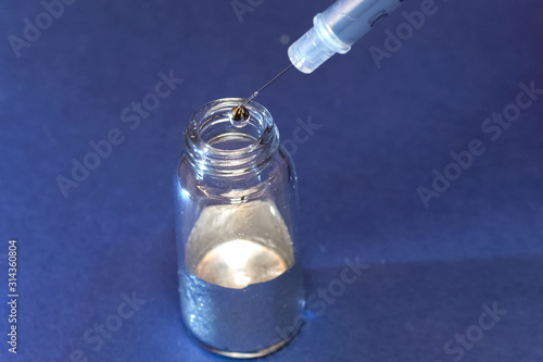 Photography Liquid metal in flask. Take liquid metal with a syringe.