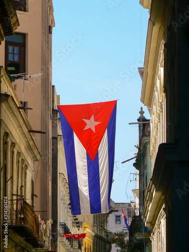 A Cuban flag hanging from a building in Old Havana © Rob