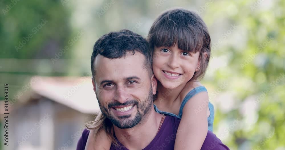 Brazilian little girl sitting on her fathers shoulders. 4K. Brazilian little girl sitting on her fathers shoulders. 4K.