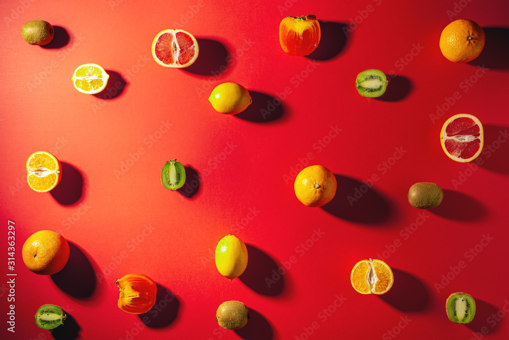 Flat lay composition with tangerines and citrus fruits on red background Flat lay composition with tangerines and citrus fruits on red background
