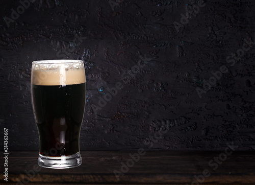 Wallpaper Mural Glass of beer on wood dark background with copyspace for text