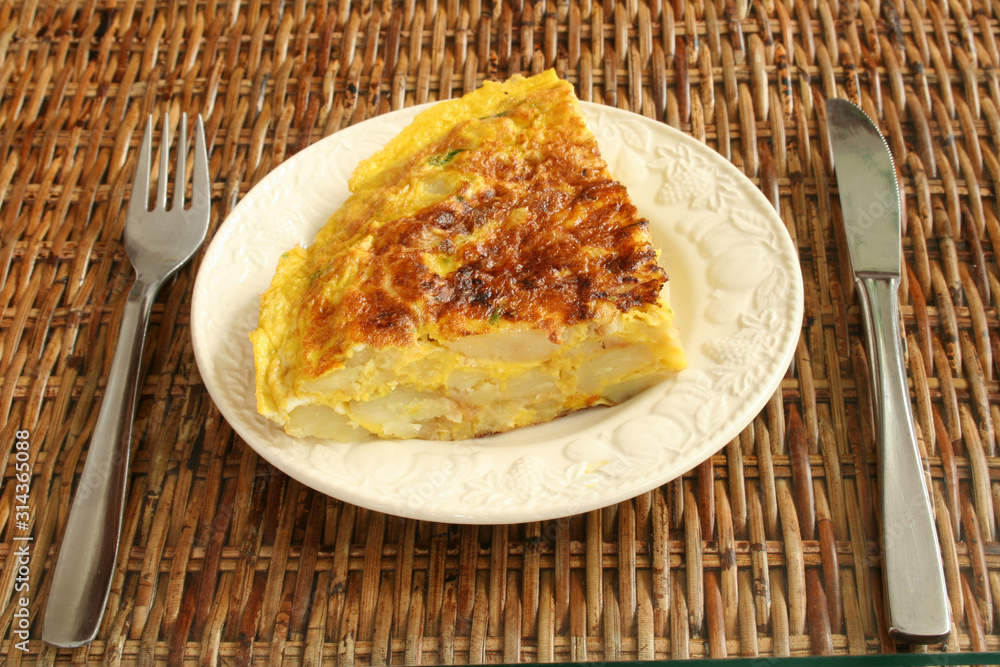 Piece od Spanish omelet on a mat for snack Piece od Spanish omelet on a mat for snack