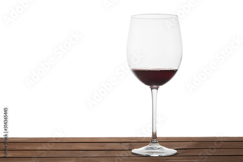 Glass of red wine on a table with isolated background