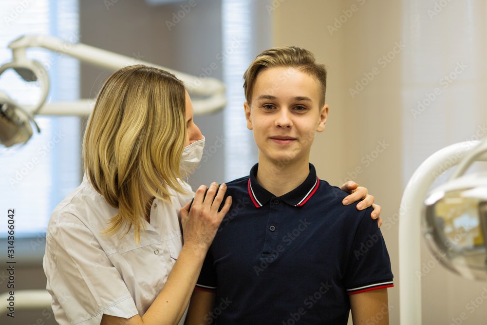 Woman dentist with a patient guy, portrait in stomatology clinic. Woman dentist with a patient guy, portrait in stomatology clinic.
