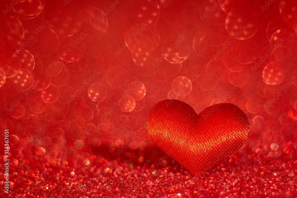 Red heart on blurred red bokeh background. Symbol of love. Valentine's Day