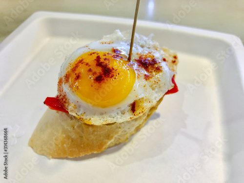 Spanish Pincho with fried egg and red bell pepper