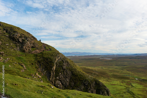 Woman sitting on a mountain at Quiraing on the Isle of Skye