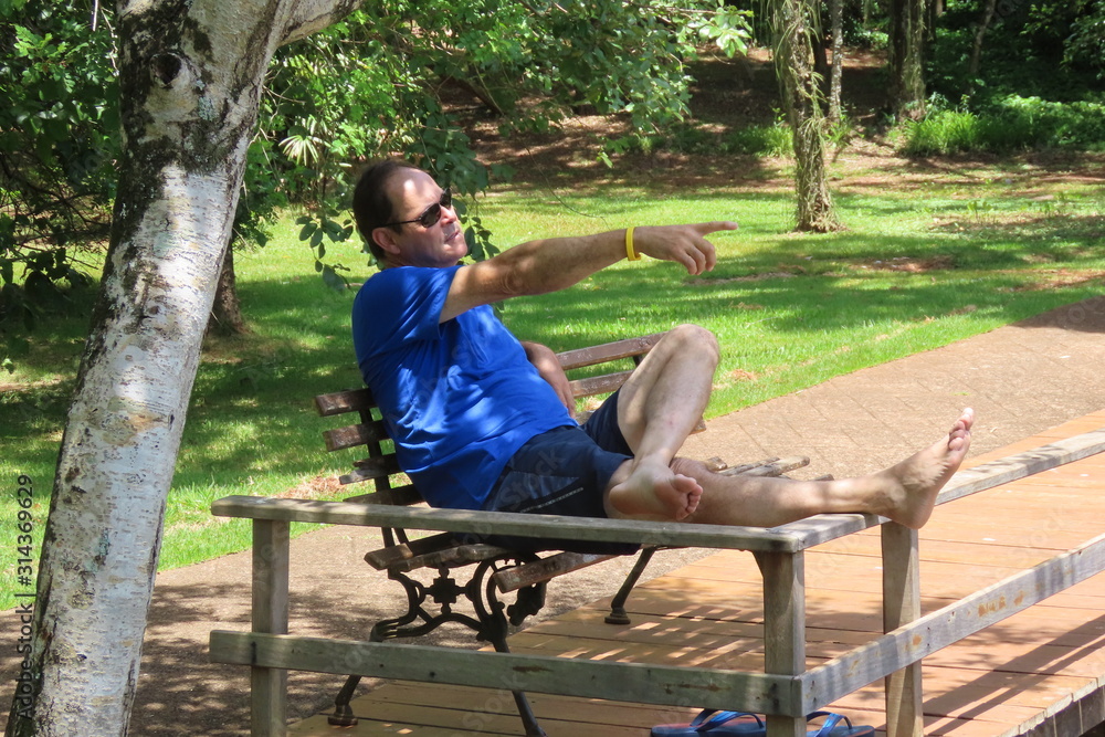 man sitting on a bench in the park man sitting on a bench in the park