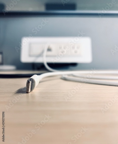 Phone cable connected to blurred outlet