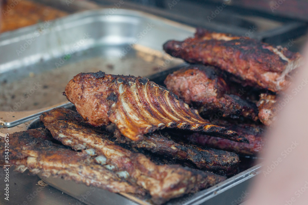 Grilled pork ribs on the grill at street food festival