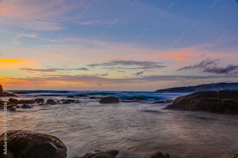 Obraz premium Long exposure picture of colorful sunset at Kamala beach in Thailand in summer