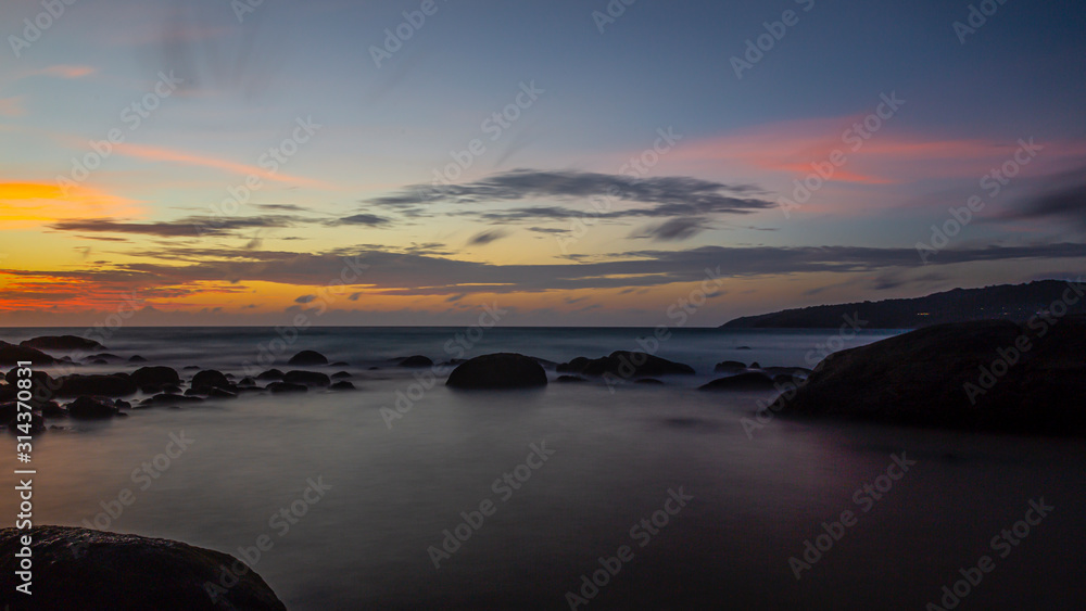 Long exposure picture of colorful sunset at Kamala beach in Thailand in summer Long exposure picture of colorful sunset at Kamala beach in Thailand in summer