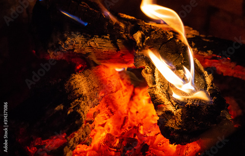 Close up of Burning Woods and Embers inside of a Fireplace.