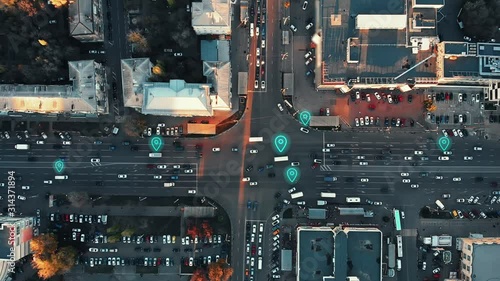 Aerial view of city intersection with many cars and GPS navigation system symbols. Autonomous driverless vehicles in city traffic. Future transportation concept
