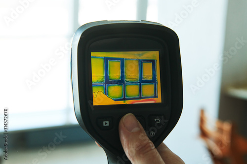 thermal imaging camera at apartment inspection for finding heating leakage