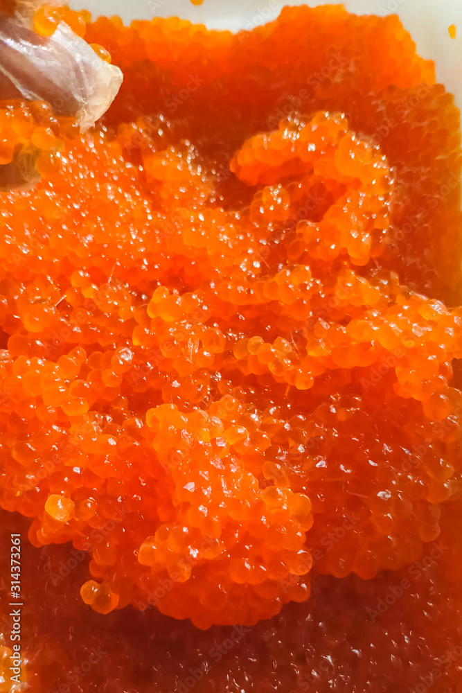 red caviar in plastic container. Salmon caviar, diet food. red caviar in plastic container. Salmon caviar, diet food.
