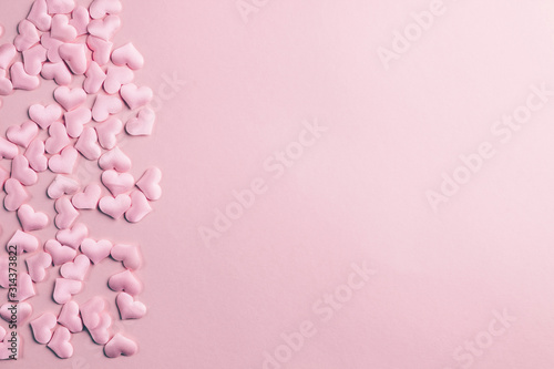 Pink heart confetti on pink background. Festive holiday pastel backdrop. Flat lay. Top view. Copy space © juliamikhaylova