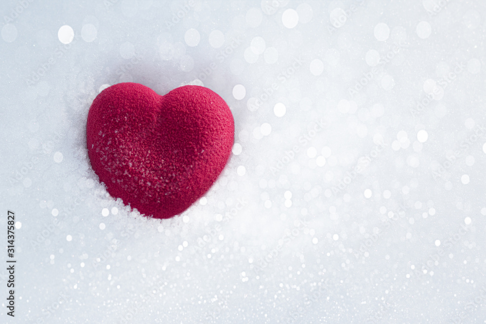 Red heart in sparkling snow. Valentines day concept