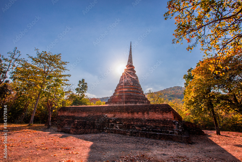 Background of the tourist attraction, the large ancient chedi (Wat Chedi Ngarm) in Sukhothai province, which is a historic site worth worthy of conservation for future generations to study further.