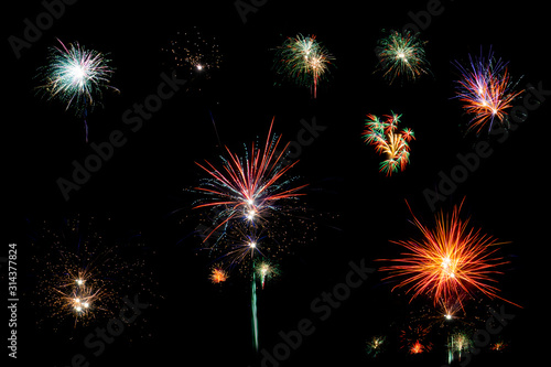 Set of unique burning festive fireworks glowing in different colors isolated on black background