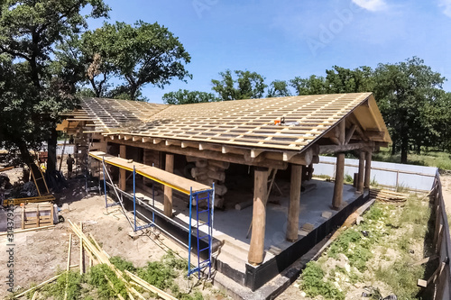 Stage of construction of a wooden house.